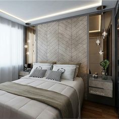 a bedroom with a bed, nightstands and mirror on the wall next to it