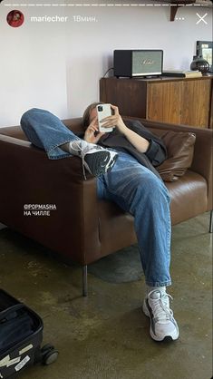 a person laying on a couch taking a selfie