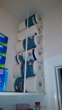 several rolls of toilet paper are stacked on top of each other in a bathroom closet