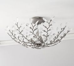 a chandelier hanging from the ceiling in a room with white walls and ceilings