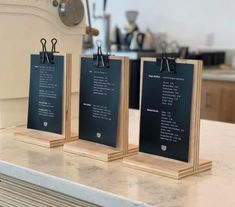 three small menus are sitting on a counter