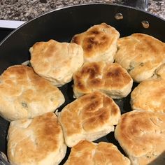 some biscuits are cooking in a pan on the stove