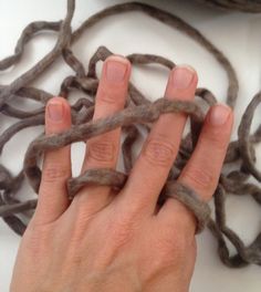 a woman's hand is holding some kind of rope