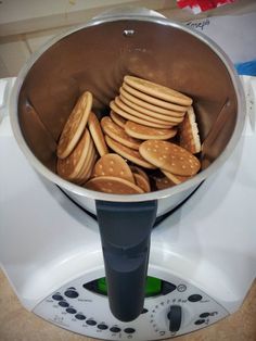 a pan filled with cookies sitting on top of a counter next to a blender