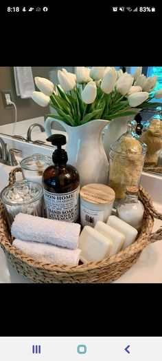 a basket filled with lots of different items on top of a bathroom counter next to a sink