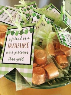 there is a green plate with gold foiled candies on it and a sign that says, a friend is a treasure more precious than god