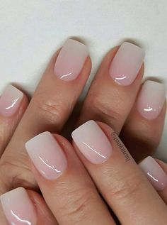 a woman's hands with french manies and pink nail polish on their nails