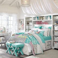 a bedroom with a bed, desk and bookcases on the shelves in front of it