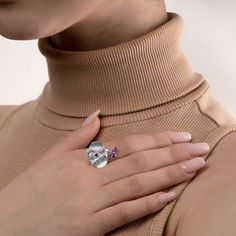 a woman's hand with a ring on her neck