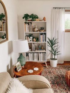 a living room filled with lots of furniture and bookshelves