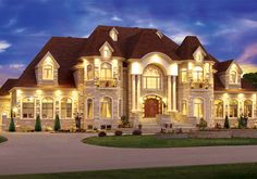 a large house with lots of windows and lights on it's front lawn area