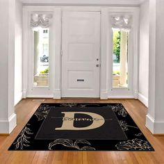 a black and white welcome mat in front of a door