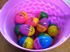 a purple bucket filled with lots of colorful candy eggs