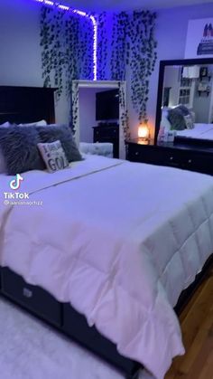 the bedroom is decorated with purple flowers and greenery, along with a bed in the background