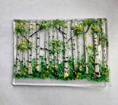a glass plate with trees painted on it