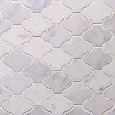 a white and grey tile with wavy lines