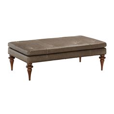 a bench with wooden legs and a footstool on top of it's cushion