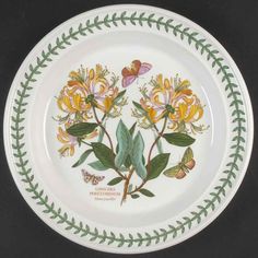 a plate with flowers and butterflies painted on it