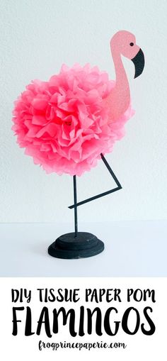 a pink paper flamingo on a black stand