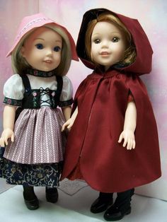 two dolls are standing next to each other