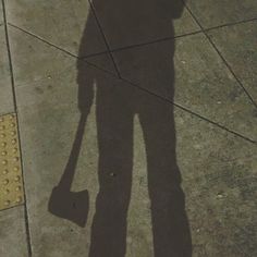 the shadow of a person holding an umbrella