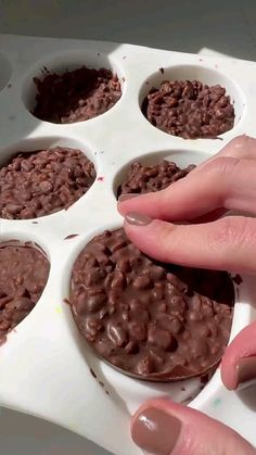 chocolate peanut butter crunch cups in a muffin tray with a sticker that says chocolate peanut crunch