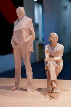 two wooden sculptures sitting on top of a table
