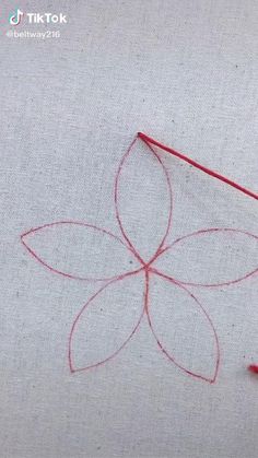 a piece of fabric with red thread on it
