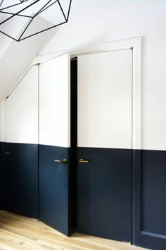 an empty room with blue and white doors