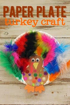 a paper plate turkey craft with feathers on it