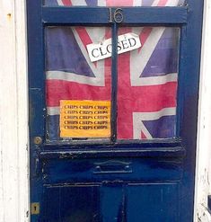 a blue door with a sign on it that says closed in front of a british flag