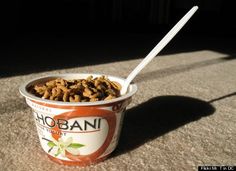a bowl of cereal with a spoon in it sitting on the ground next to a wall