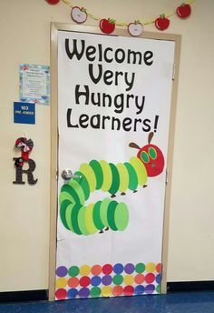 a classroom door decorated with the very hungry caterpillars and welcome very hungry learners