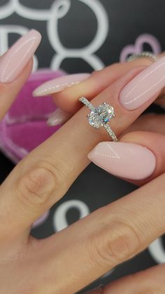 a woman's hand with pink manies and a diamond ring on her finger