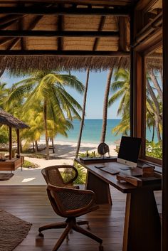 a desk with a laptop on top of it in front of palm trees and the ocean