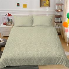 a bed room with a neatly made bed and balloons