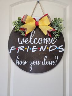 a welcome sign hanging on the front door to someone's friends how you doin?