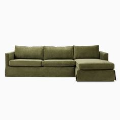 a green couch and ottoman sitting on top of a white floor next to each other