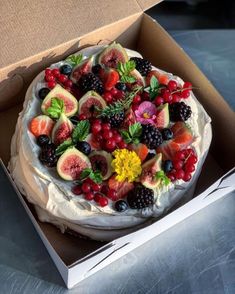 a cake in a box with fruit on it