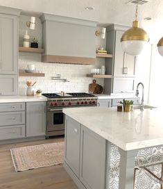 the instagram page shows an image of a kitchen with gray cabinets and white countertops