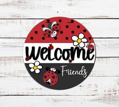 a sign that says welcome friends with ladybugs and daisies