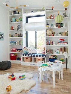 a child's playroom with toys and bookshelves