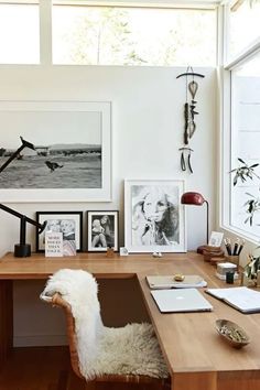 a desk with some pictures on the wall