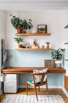 a desk with some plants on top of it and a chair in front of it