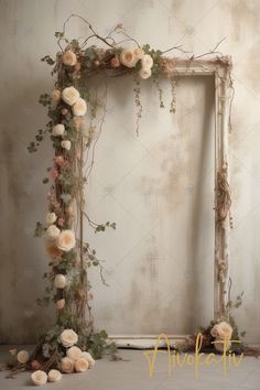 an old photo frame with flowers and vines on it in front of a white wall
