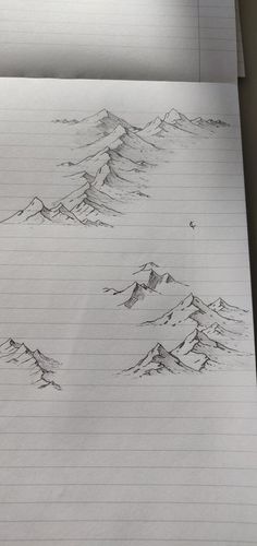 a pencil drawing of mountains on lined paper