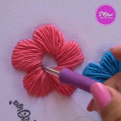 someone is working with yarn to make a flower