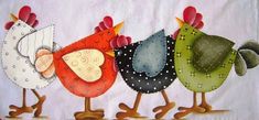 three colorful chickens are standing next to each other on a white towel with polka dots