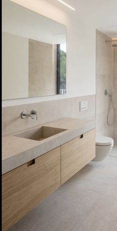 a bathroom with a sink, toilet and shower stall in it's own area