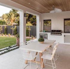 an outdoor kitchen and dining area is shown